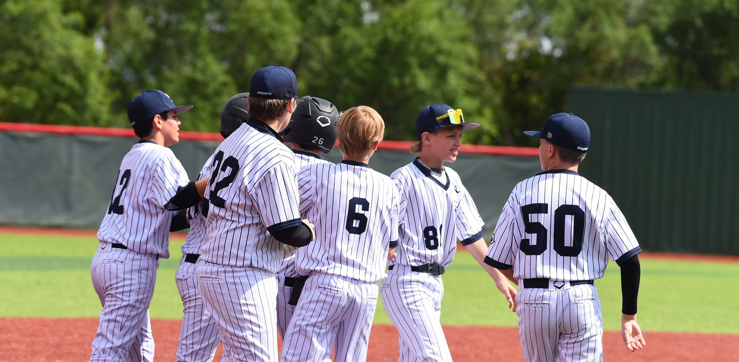 Youth baseball team huddles together