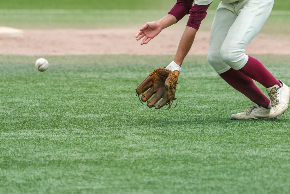 A baseball infielder approaches to field a ground ball.