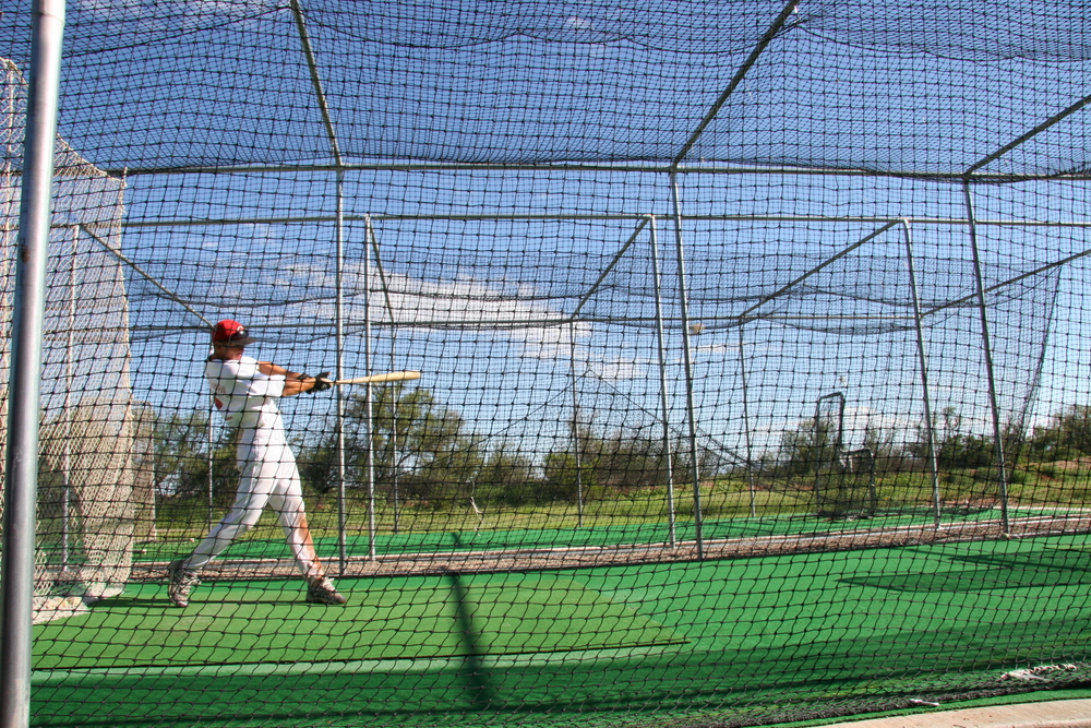A hitter takes pregame batting practice before a baseball game.
