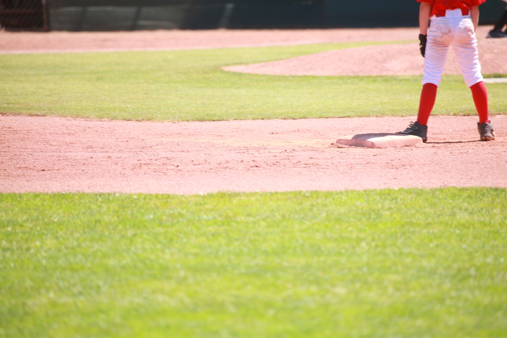 Youth Baseball Player Standing on Second Base