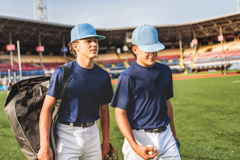 Two Youth Baseball Players Talking on a Field