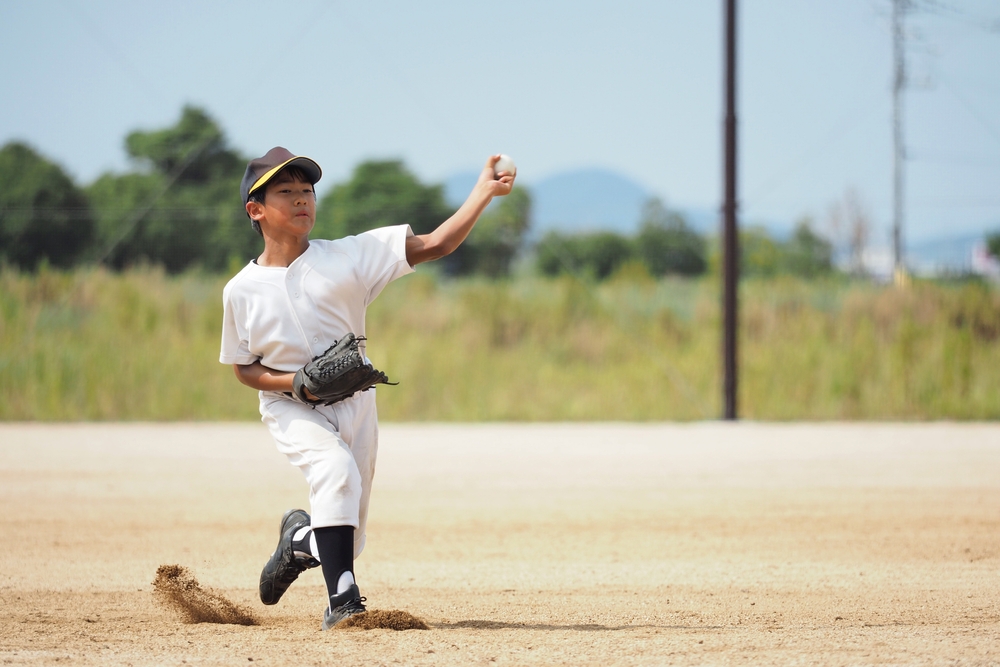 Youth Baseball Pitcher Delivering a Pitch