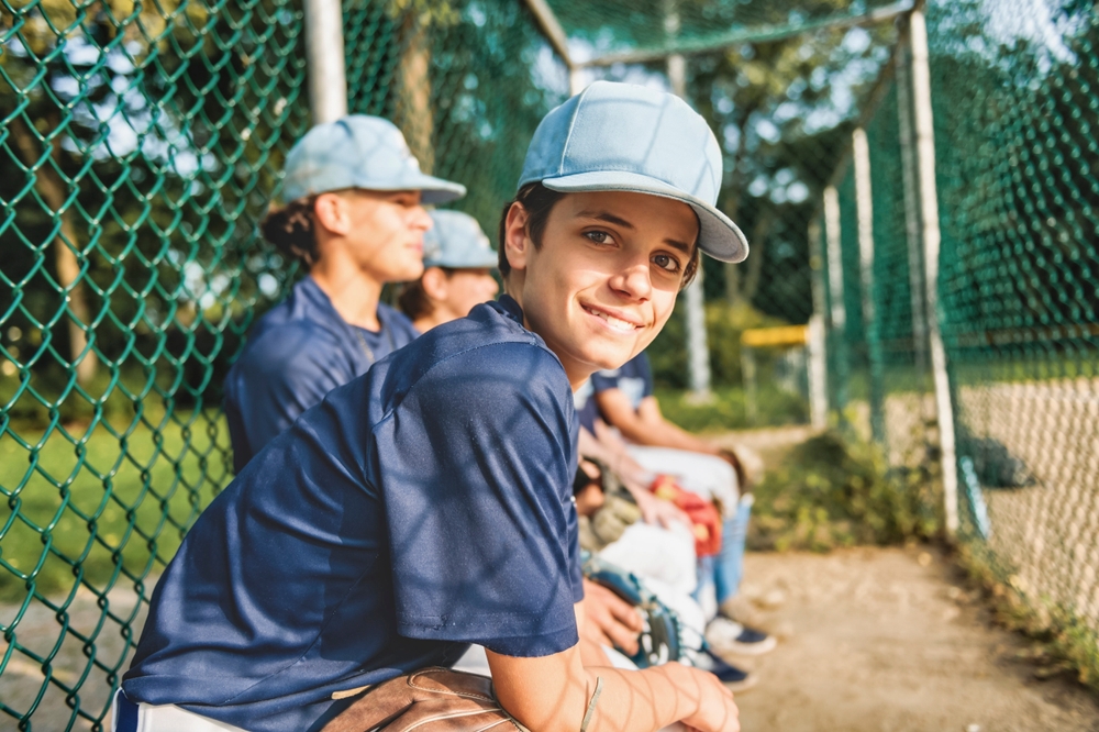 Youth Baseball Team Sitting in the Dugout